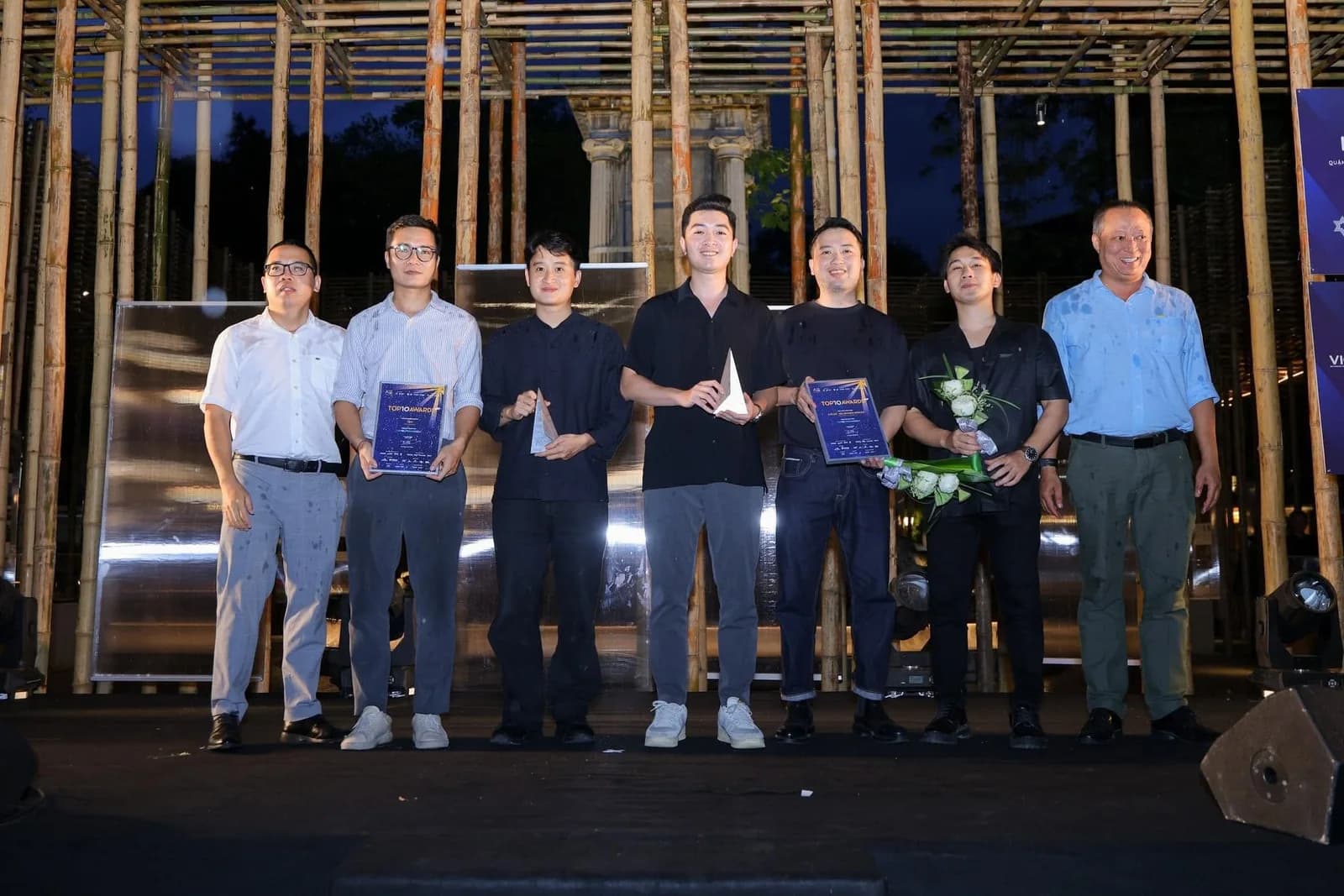 The T&Pac Architects team receiving a Top 10 Awards prize on stage